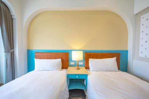 two beds sitting next to each other in a room at Kenting Long Beach Hotel in Checheng