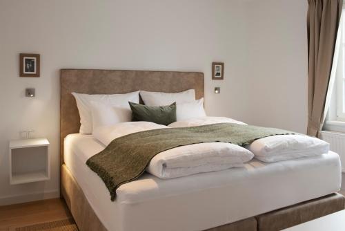 a bedroom with a white bed with pillows on it at Quartier 99 in Innsbruck
