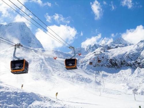 three ski lifts on a ski slope in the snow at Apartment in Neustift near Ski Lift in Neustift im Stubaital