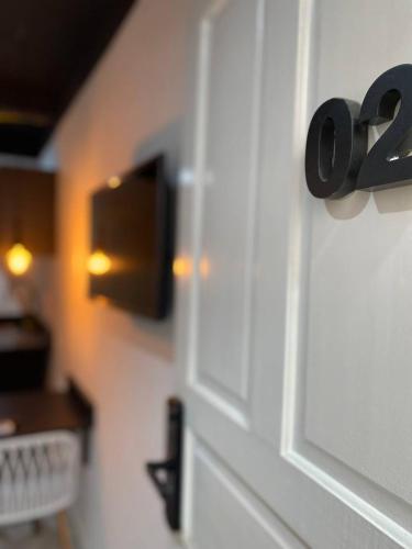 a white door with a black number on it at Ház Portuguesa in Rio de Janeiro