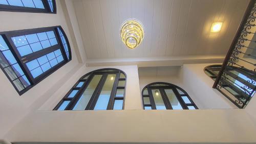 a building with three windows and a chandelier at Daddy Dream Hotel and Residence in Ranong