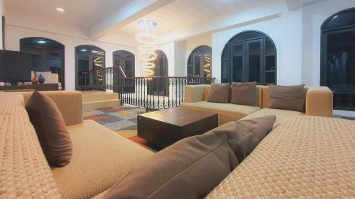 a living room with a couch and a table at Daddy Dream Hotel and Residence in Ranong