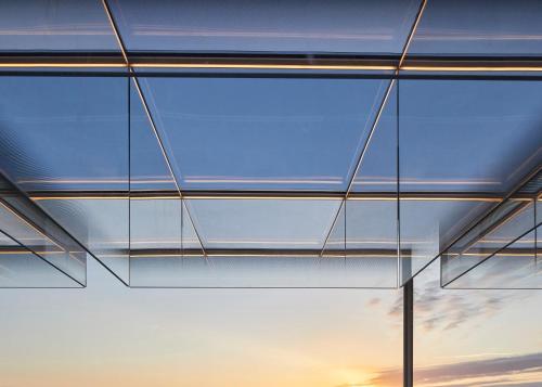 a glass ceiling in a building with a window at SO/ Paris Hotel in Paris