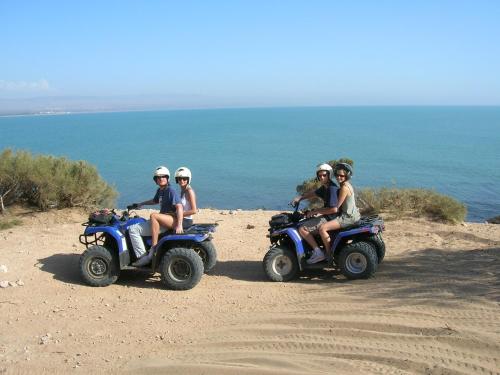 a group of people riding on atvs on a beach at RIAD ACACIA in Essaouira
