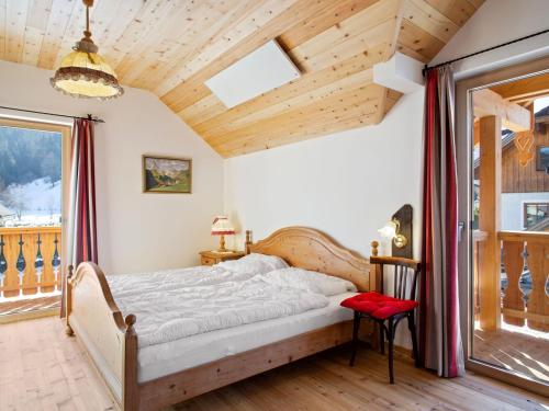 a bedroom with a bed and a wooden ceiling at Cozy holiday home with sauna in Sankt Margarethen in Sankt Margarethen im Lungau