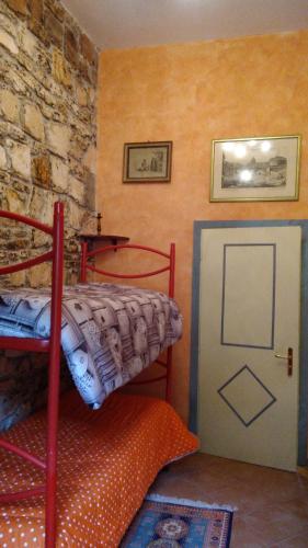 a bedroom with a bunk bed and a door at Casale delle ginestre. in Castel Madama
