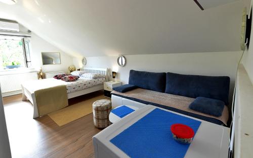 a living room with a couch and a bed at Apartment Andreja in Seliste Dreznicko