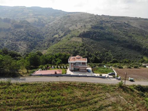 a house on the side of a mountain at Öztürk Farm House in Samsun