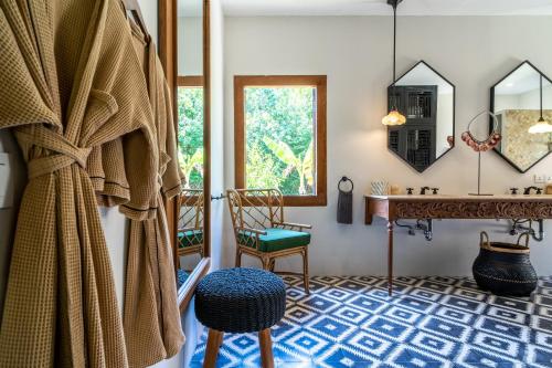 a room with a vanity and a chair and a mirror at Villa Pulau Cinta Boutique Suites in Gili Meno