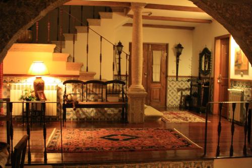 a living room with a staircase and a rug on the floor at Casa De Canilhas in Mesão Frio