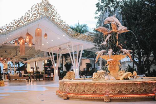 a fountain in the middle of a shopping mall at Villa Excellance Beach and Wave Pool Resort in Postema
