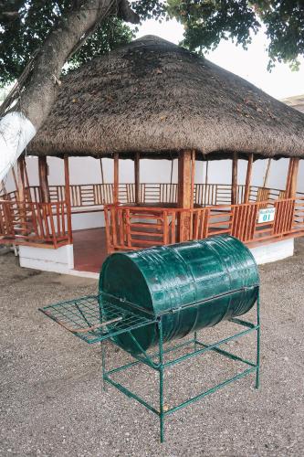 a large gazebo with a grass roof at Villa Excellance Beach and Wave Pool Resort in Postema