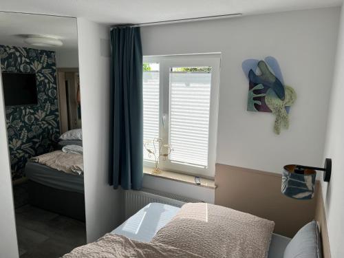 a bedroom with a bed and a window and a mirror at Apartment Siegfried in Bayreuth