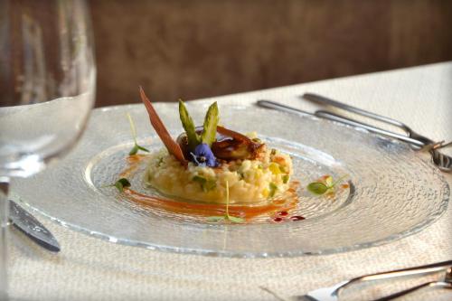 a plate with a dish of food on a table at Hotel Antines in La Villa