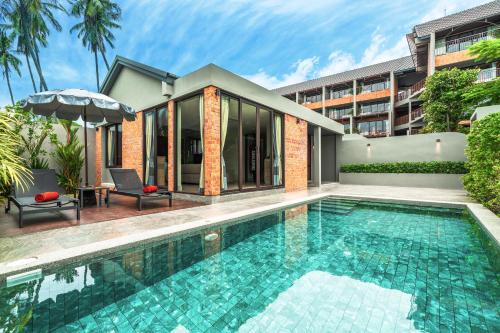 a swimming pool in front of a building at Thai Fight Hotel in Lamai