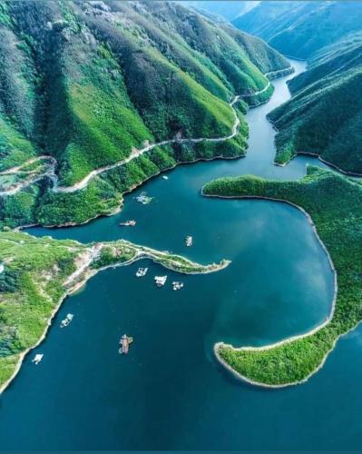 an aerial view of a lake in the mountains at Къща Томови,стаи за гости in Devin
