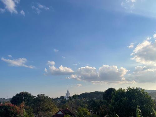 a view of a city with a tower in the distance at นอนนี่แอทเขาค้อ in Khao Kho