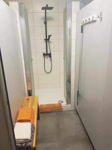 a bathroom with a shower with a bench and a shower at Barrel -schlafen im Fass in Gorleben