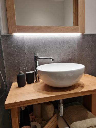 a white sink on a wooden counter in a bathroom at La Culla B&B in Padola