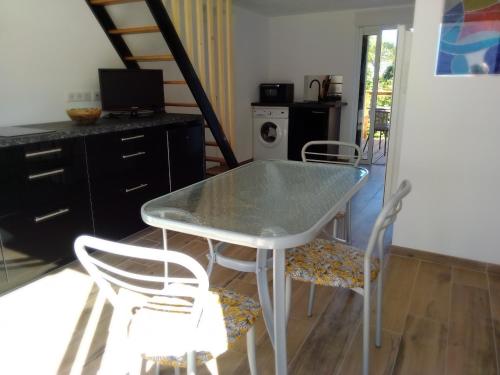 a table and chairs in a room with a kitchen at etcheland in Pont-Aven