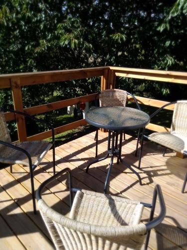 a table and chairs on a wooden deck at etcheland in Pont-Aven