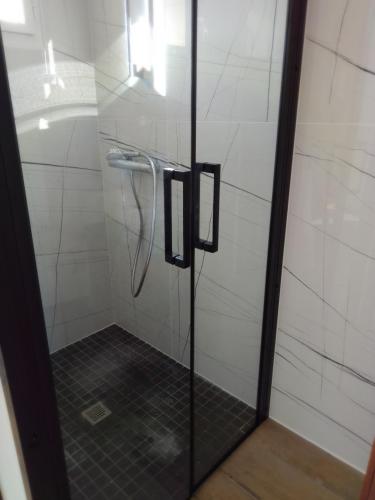 a bathroom with a shower with a glass door at etcheland in Pont-Aven