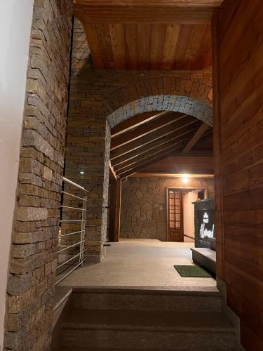 an archway in a brick building with a staircase at Chalet ALLEMAND in Sauze dʼOulx