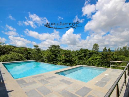 a swimming pool on a balcony with a blue sky at Norn Nab Dao RimPhu Resort in Chiang Khan