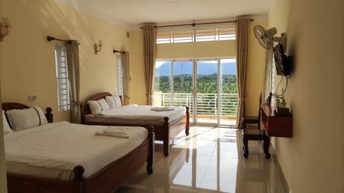 Katil atau katil-katil dalam bilik di Monica Guesthouse