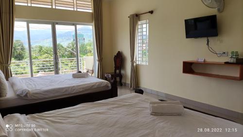 Katil atau katil-katil dalam bilik di Monica Guesthouse