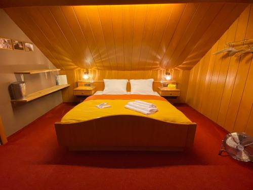 a bedroom with a bed in a small room at Honolulu Hotel in Bregenz