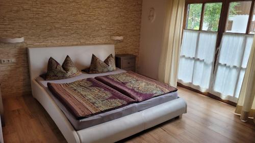 a bedroom with a large bed with pillows on it at Heike Hauswirth KOFELBLICK in Oberammergau