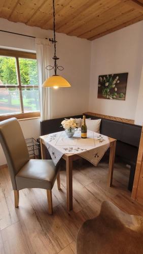 a dining room with a table and a couch at Heike Hauswirth KOFELBLICK in Oberammergau