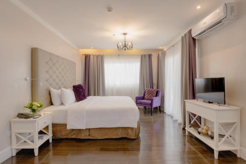 a hotel room with a bed and a tv at Sta Barbara Residence Hotel in Cebu City