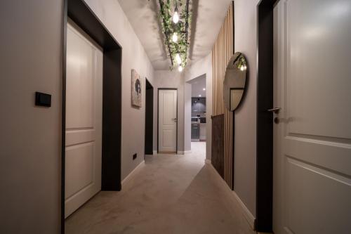 a hallway with white walls and a ceiling with lights at La Bodega - Designer Apartment an der Alster in Hamburg