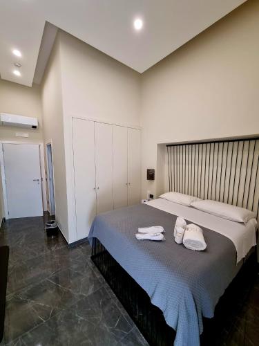 a bedroom with a large bed with towels on it at Il Salotto della Regina in Naples