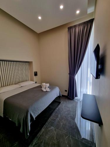 a bedroom with a bed and a large window at Il Salotto della Regina in Naples