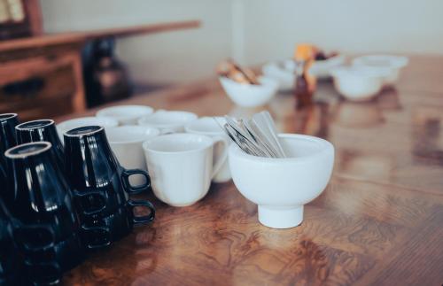 a group of white bowls sitting on a wooden table at Nadden Hotell & Konferens in Ramnäs