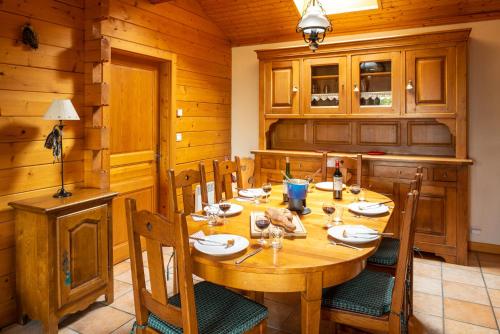 une salle à manger avec une table et des chaises en bois dans l'établissement Chalet Chardon Lac, aux Gets
