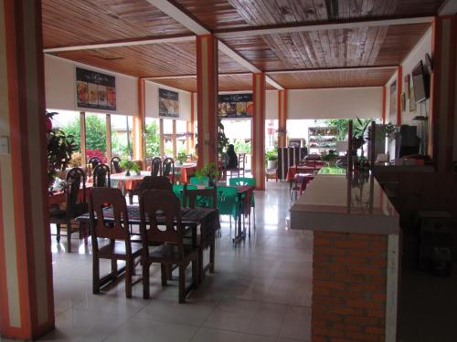 a dining room with tables and chairs in a restaurant at Lekjon Cottage in Tuktuk Siadong