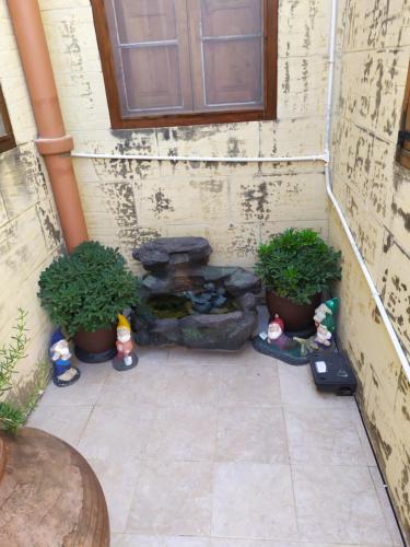 a patio with a fire pit and potted plants at Gozo Rustic Farmhouse with stunning views and swimming pool in Sannat