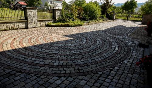 a brick driveway with a circular pattern on it at Apartmán na Pasekách in Bystrzyca