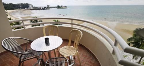 a table and chairs on a balcony overlooking the beach at Tanjung Tuan Beach Regency - Hermis Theme 1 Car Park in Kampong Baharu
