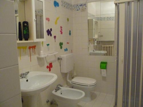 y baño con aseo y lavamanos. en LOCANDA SAN GALLO, en Moggio Udinese