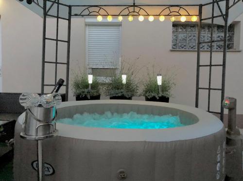 a jacuzzi tub with blue water in a room at Holiday house "Mimoza" 2 massage pools in Otočac