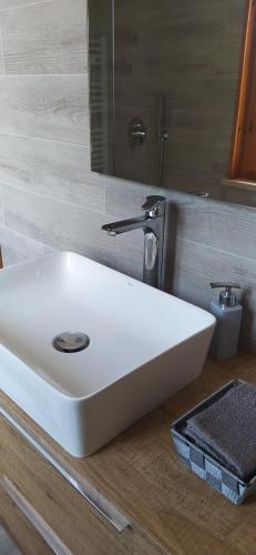a white sink in a bathroom with a mirror at Soggiorno in Relax in Correggioverde