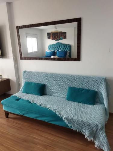 a bedroom with a bed with a mirror on the wall at Terraço Harmony Flats GRU in Guarulhos