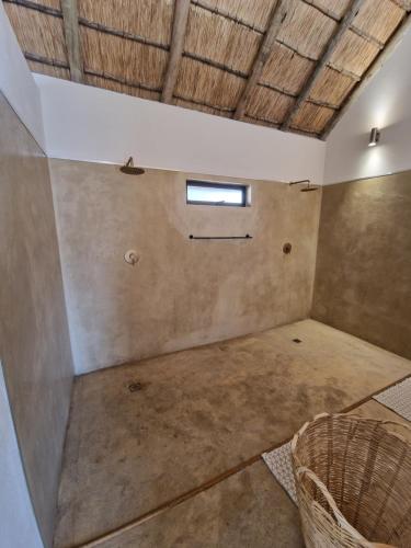 an empty room with a window in the ceiling at Pata Pata House in Marloth Park