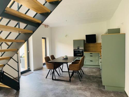 a kitchen and dining room with a table and chairs at Deichgraf „Die Elbpension“ in Dornburg