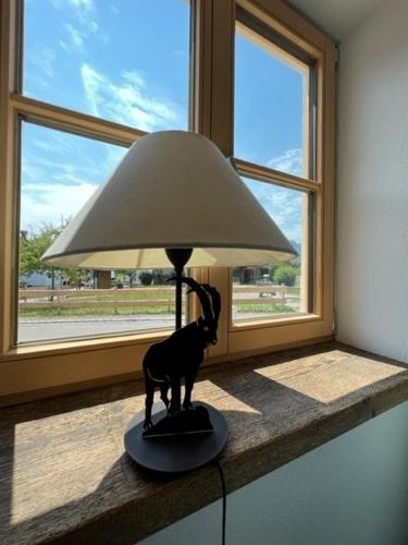 a lamp sitting on a counter next to a window at "Fewo am Dorfplatz" - Annehmlichkeiten von 4-Sterne Familien-und Wellnesshotel Viktoria können mitgenutzt werden in Oberstdorf
